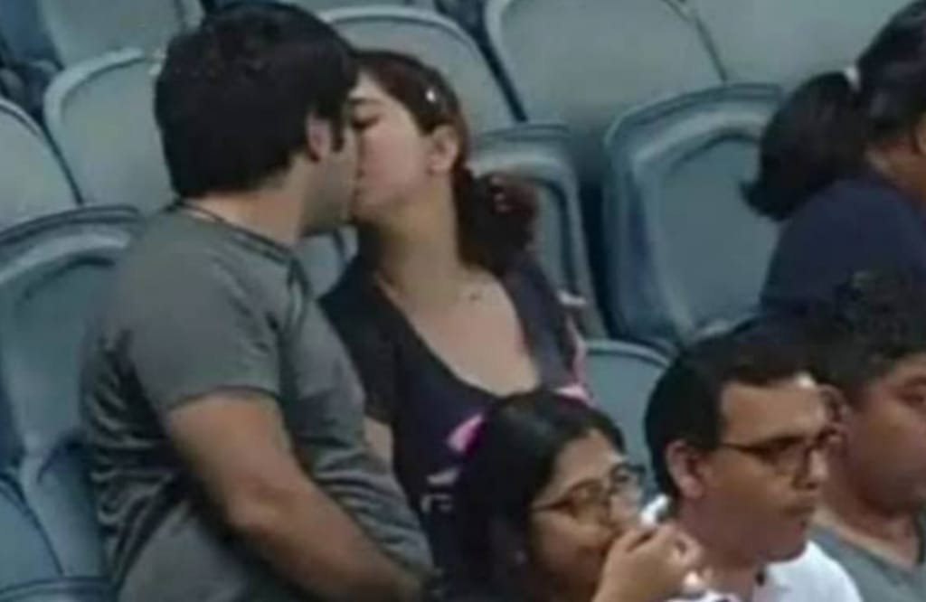 people kissing in stands